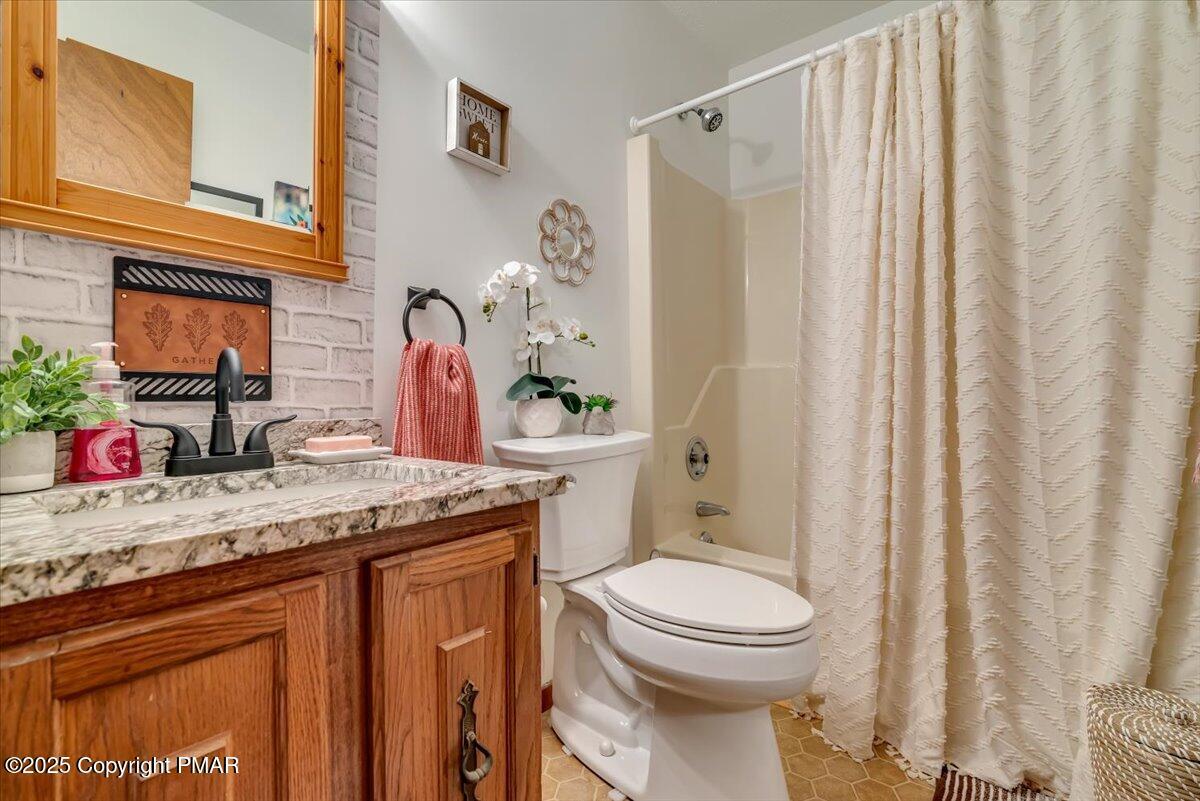1037 Porter Drive Bushkill, PA 18324 - Photo 14 of 45 a bathroom with a granite countertop sink toilet and shower