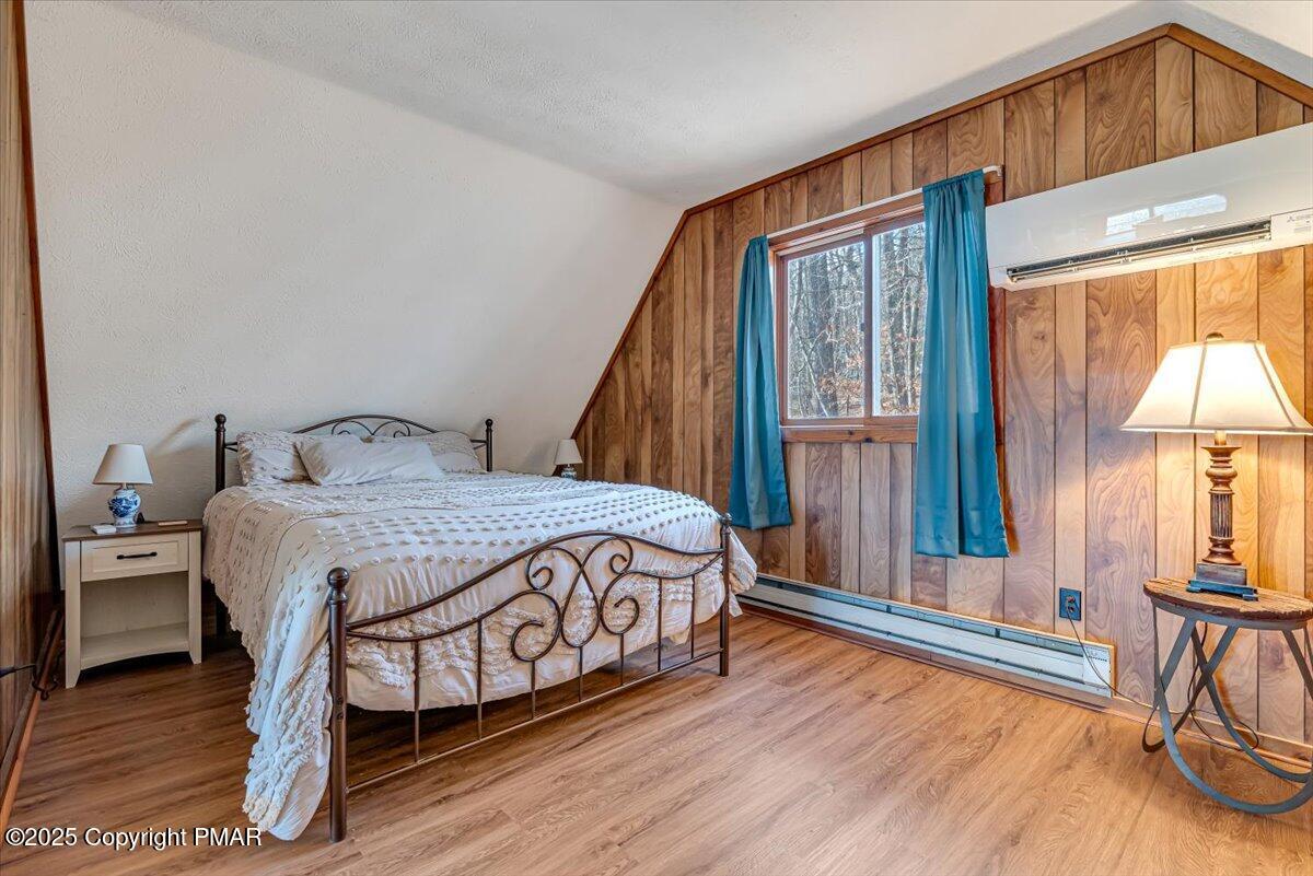 1037 Porter Drive Bushkill, PA 18324 - Photo 19 of 45 a bedroom with a bed and a large window with chair
