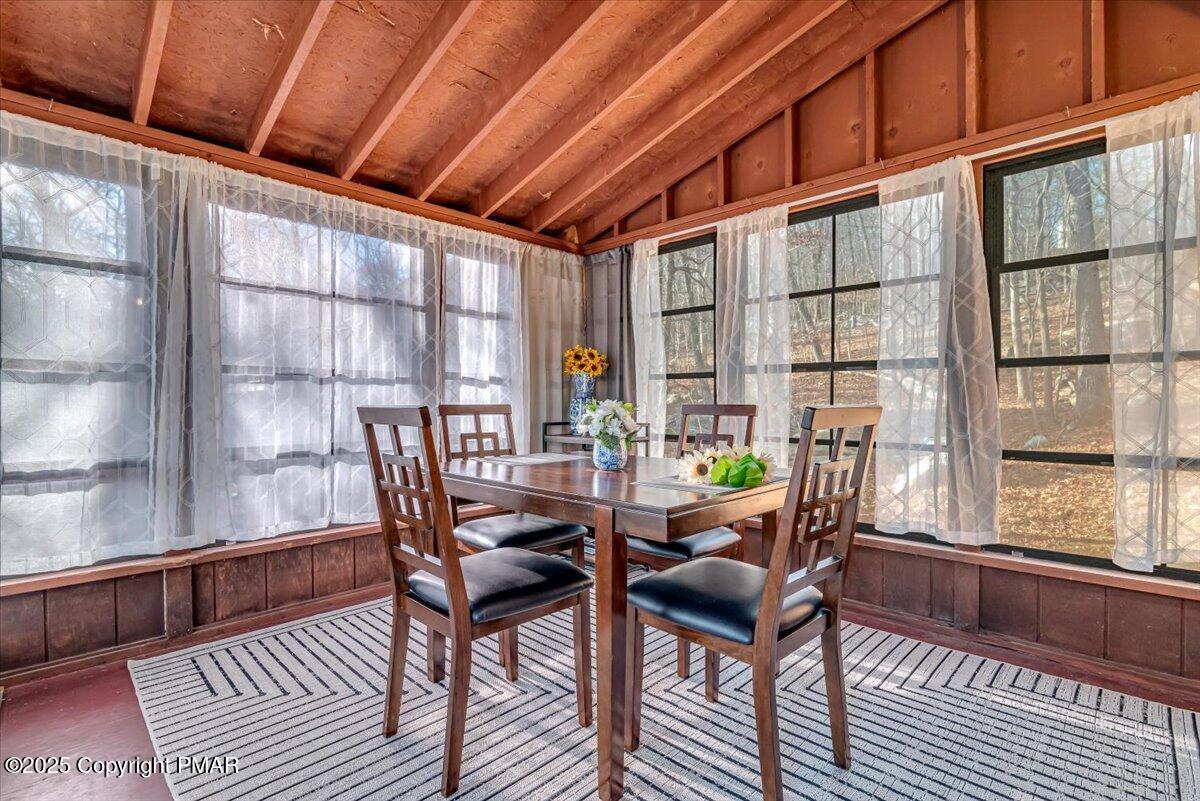1037 Porter Drive Bushkill, PA 18324 - Photo 24 of 45 a dining room with furniture a rug and wooden floor
