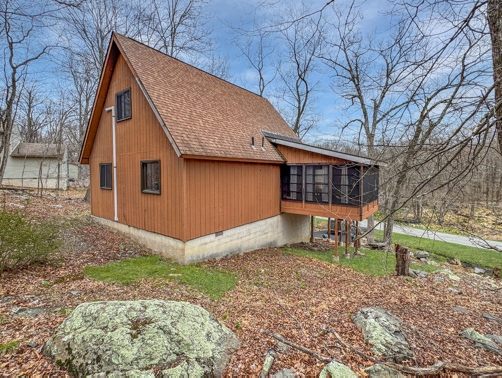 1037 Porter Drive Bushkill, PA 18324 - Photo 34 of 45 a house that has a tree in front of it