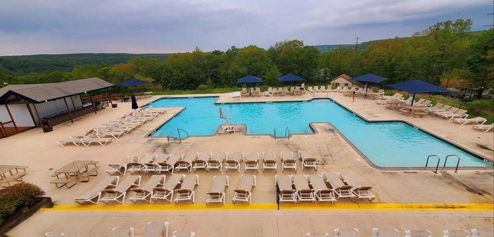 1037 Porter Drive Bushkill, PA 18324 - Photo 45 of 45 a view of a swimming pool with an outdoor space and seating area