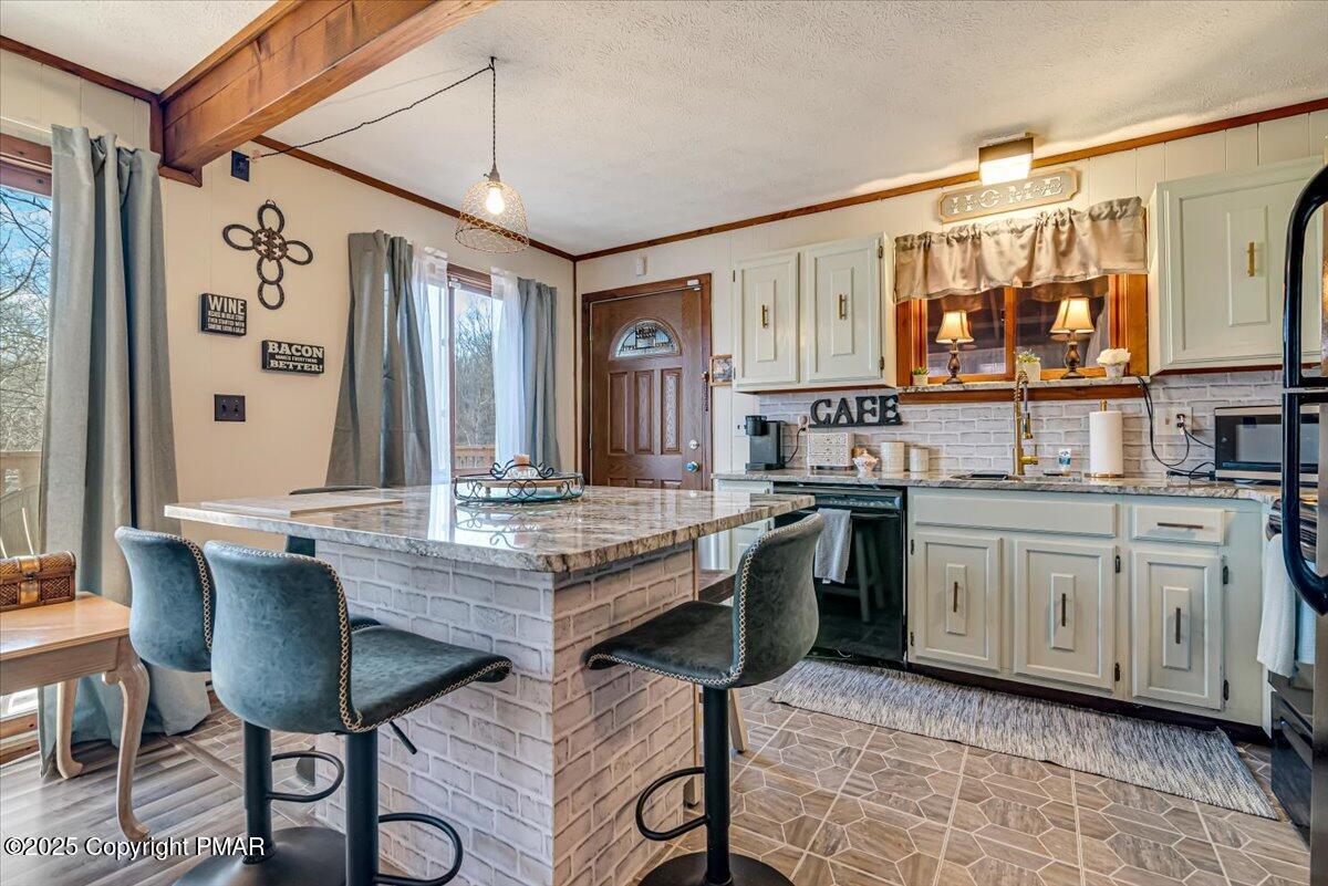 1037 Porter Drive Bushkill, PA 18324 - Photo 5 of 45 a kitchen with granite countertop a sink cabinets and stove top oven
