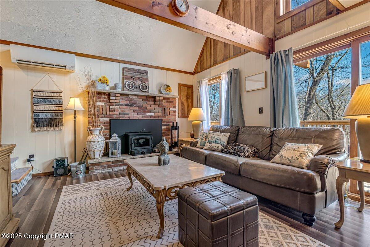 1037 Porter Drive Bushkill, PA 18324 - Photo 8 of 45 a living room with furniture a flat screen tv and a fireplace