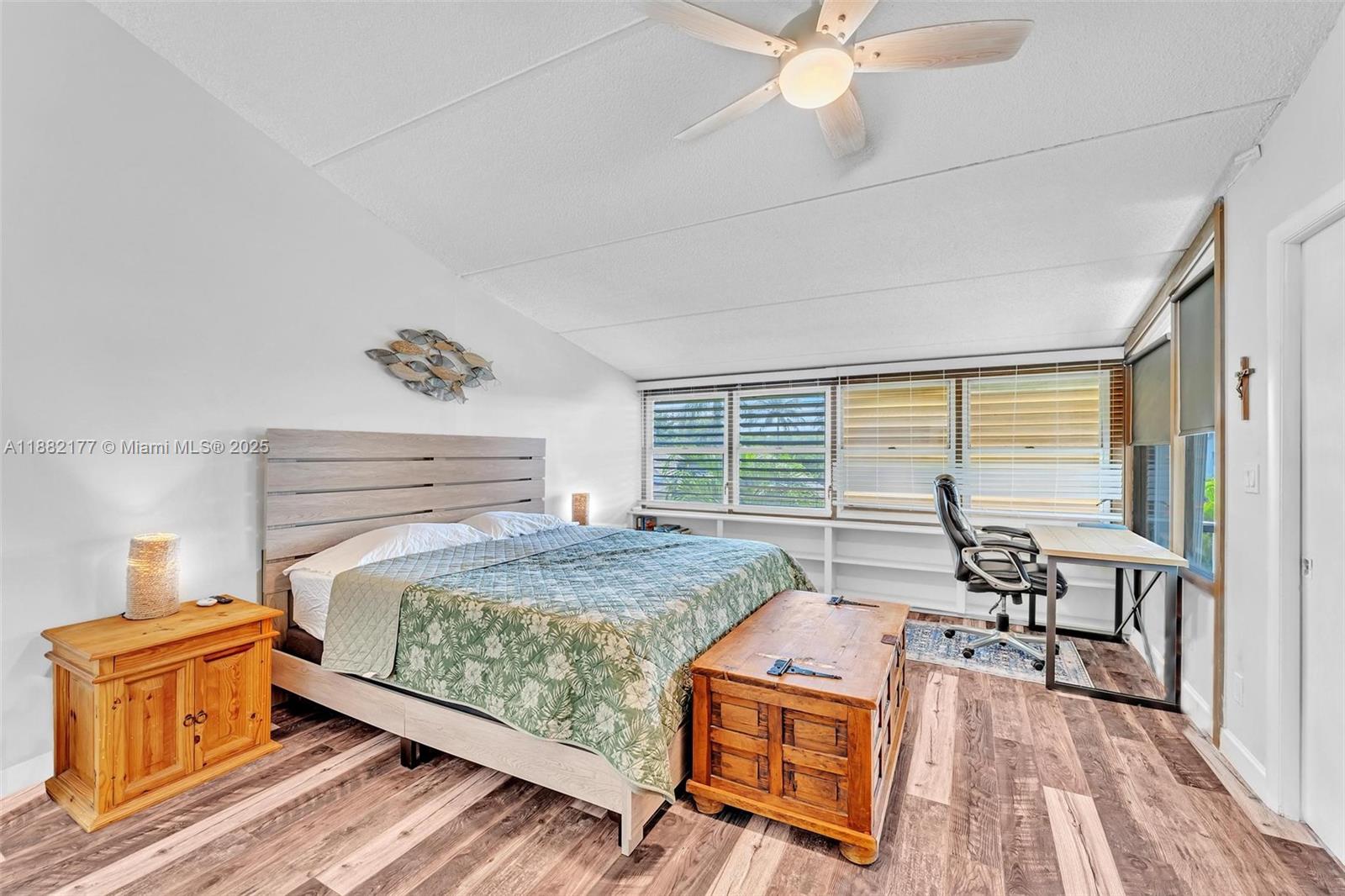 1456 Northeast Ocean Boulevard, Unit 7204 Stuart, FL 34996 - Photo 11 of 64 a bedroom with a bed and wooden floor