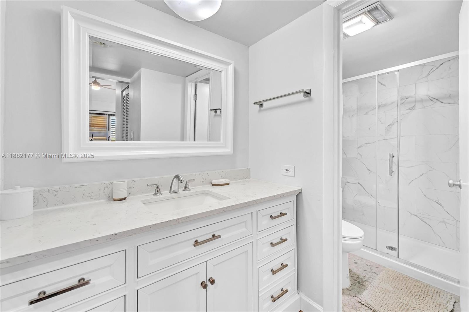 1456 Northeast Ocean Boulevard, Unit 7204 Stuart, FL 34996 - Photo 14 of 64 a bathroom with a sink a toilet and shower