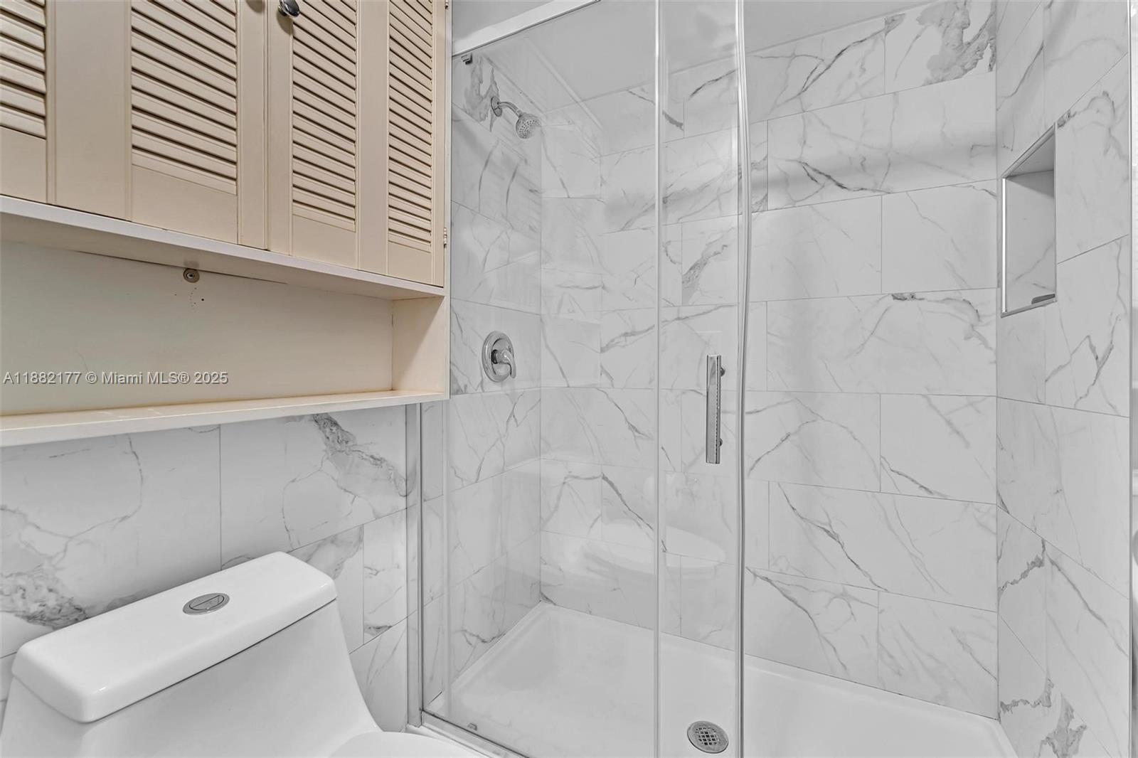 1456 Northeast Ocean Boulevard, Unit 7204 Stuart, FL 34996 - Photo 15 of 64 a bathroom with a shower and toilet