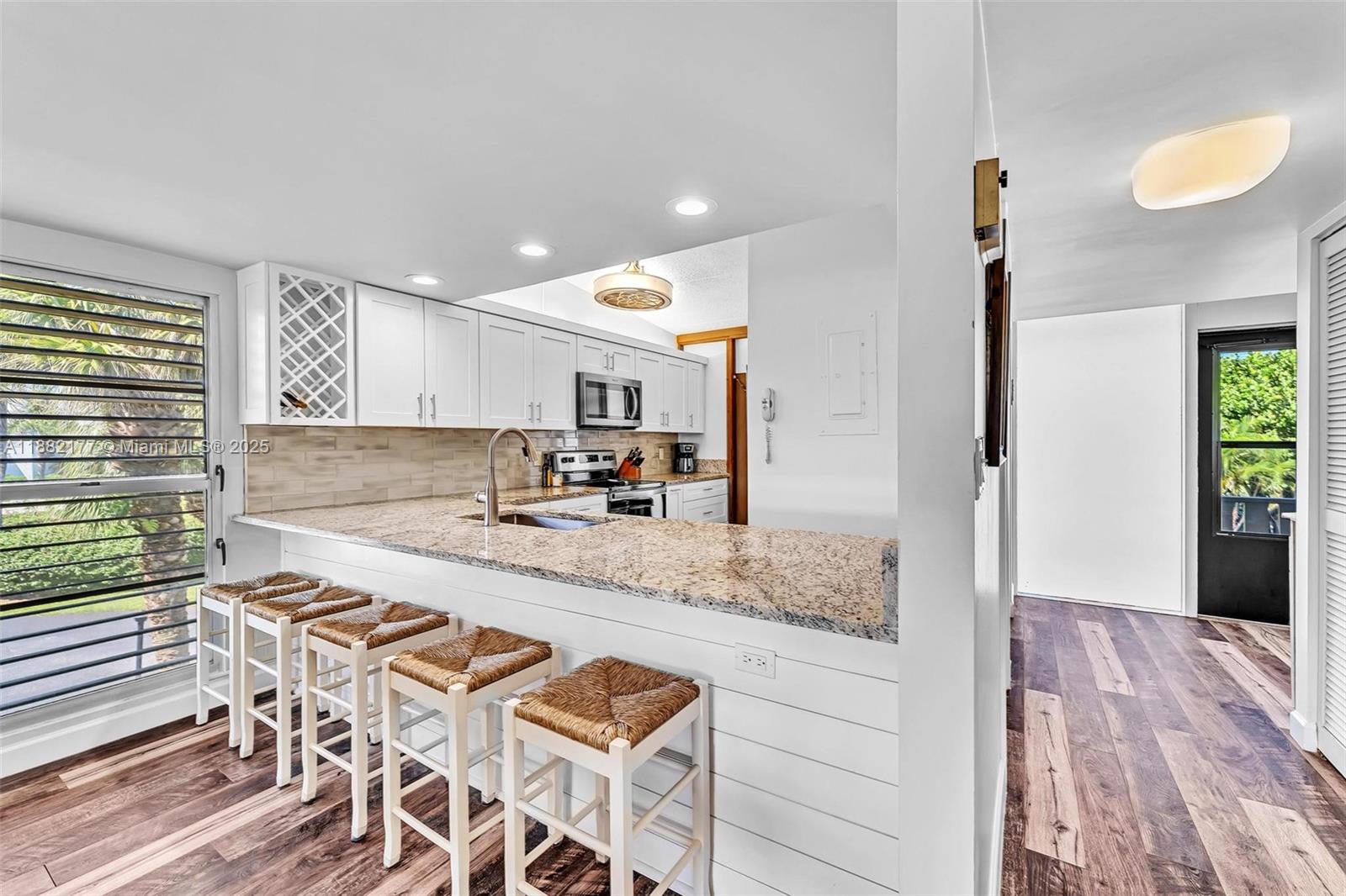 1456 Northeast Ocean Boulevard, Unit 7204 Stuart, FL 34996 - Photo 21 of 64 a large kitchen with kitchen island a sink stainless steel appliances and cabinets