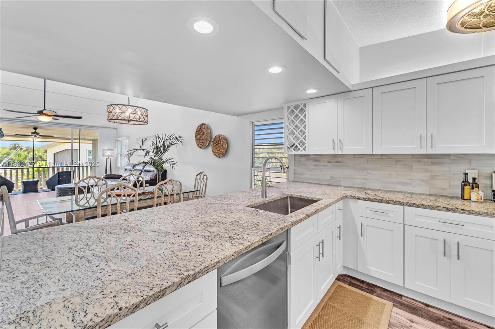 1456 Northeast Ocean Boulevard, Unit 7204 Stuart, FL 34996 - Photo 23 of 64 a kitchen with a sink and cabinets