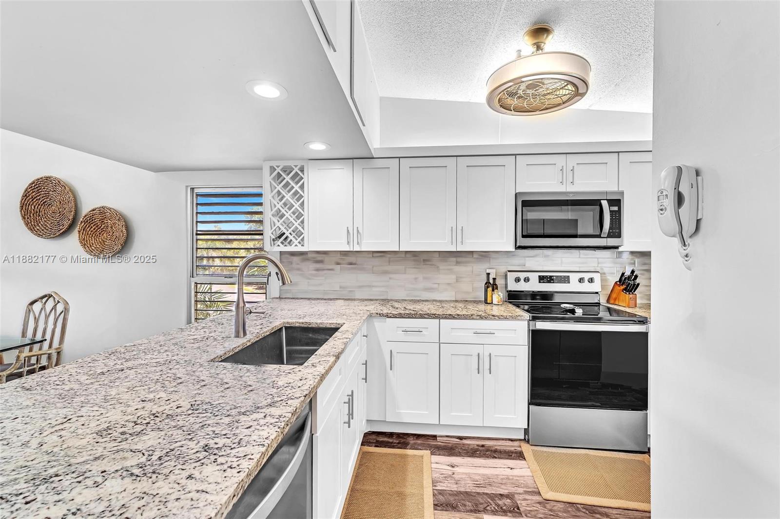 1456 Northeast Ocean Boulevard, Unit 7204 Stuart, FL 34996 - Photo 24 of 64 a kitchen with a stove and a sink