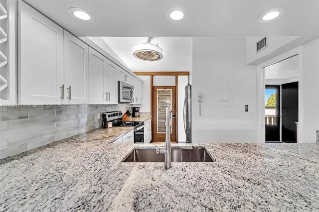 a view of a dining room with furniture a chandelier and wooden floor