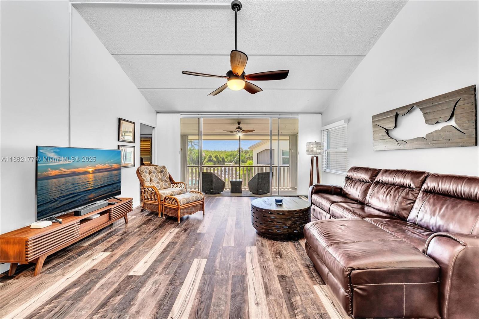 1456 Northeast Ocean Boulevard, Unit 7204 Stuart, FL 34996 - Photo 31 of 64 a living room with furniture and a flat screen tv