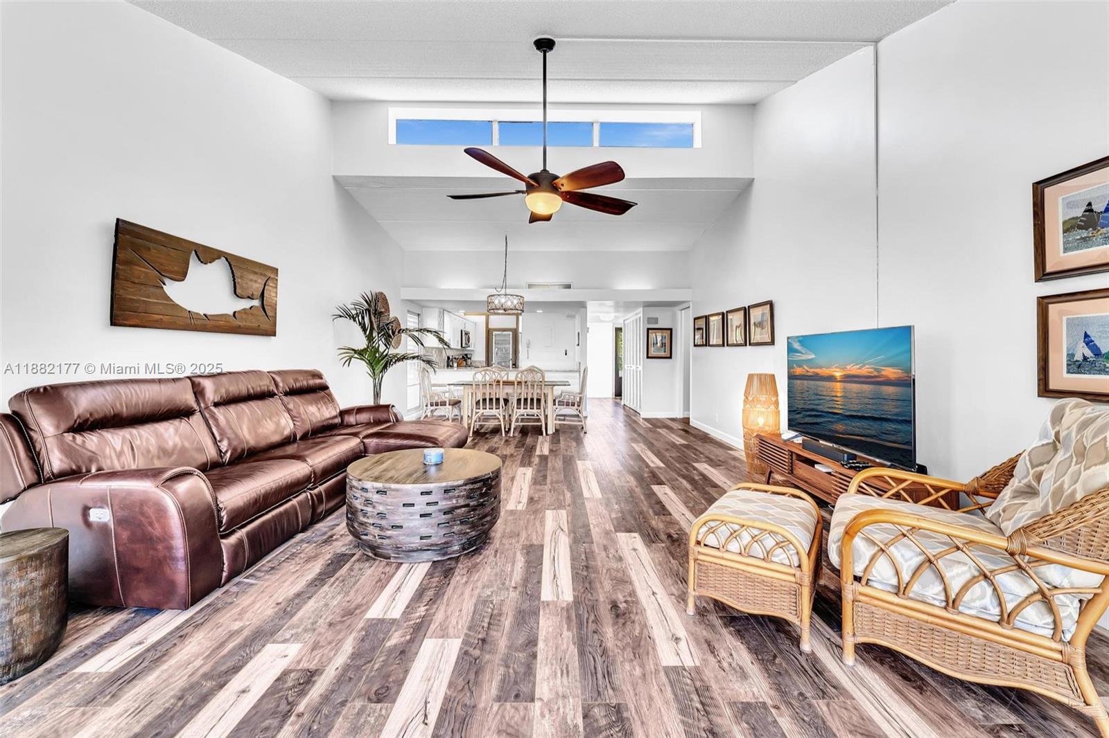 1456 Northeast Ocean Boulevard, Unit 7204 Stuart, FL 34996 - Photo 32 of 64 a living room with furniture a flat screen tv and a ceiling fan