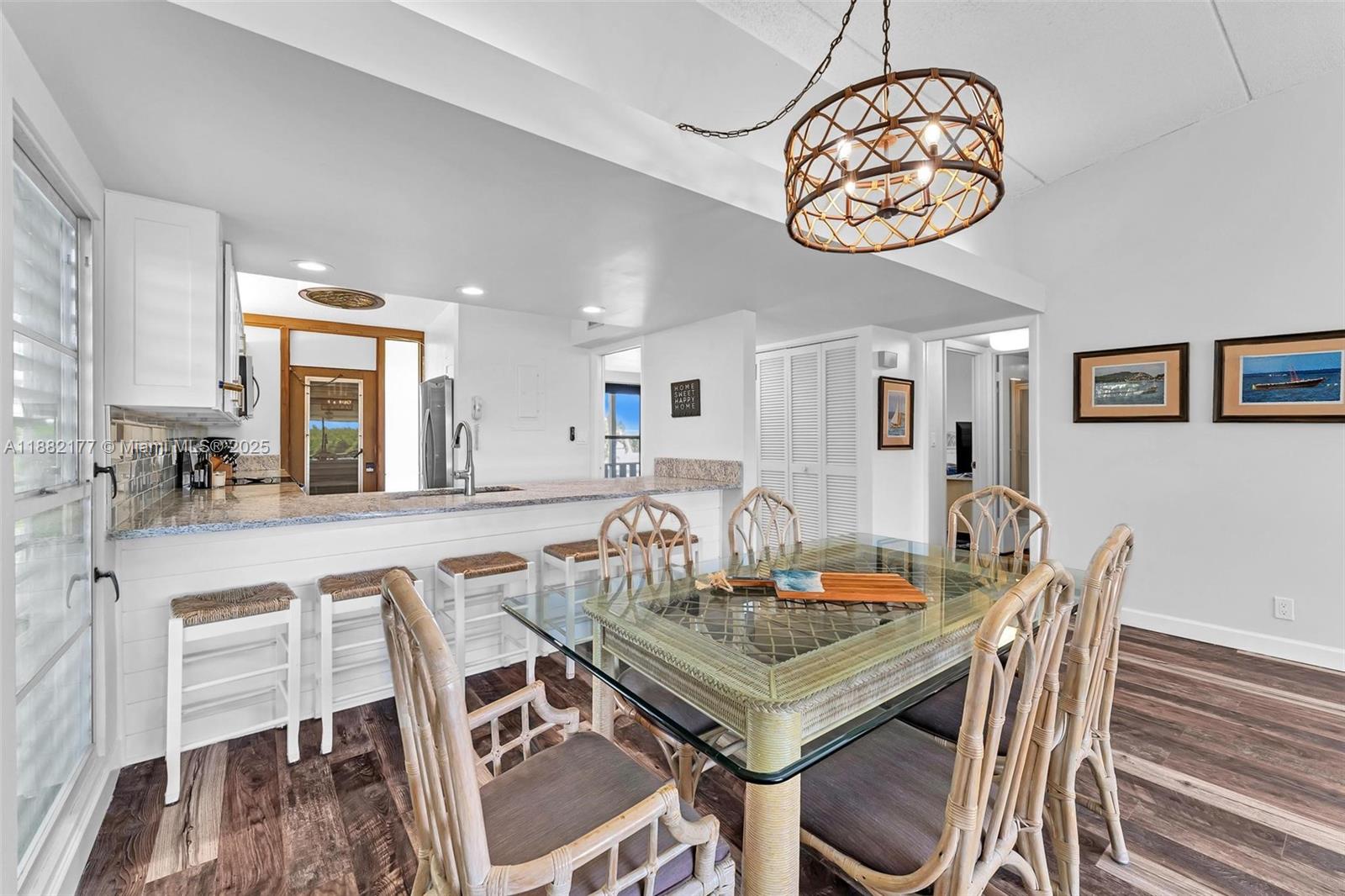 1456 Northeast Ocean Boulevard, Unit 7204 Stuart, FL 34996 - Photo 35 of 64 a view of a dining room with furniture a chandelier and wooden floor