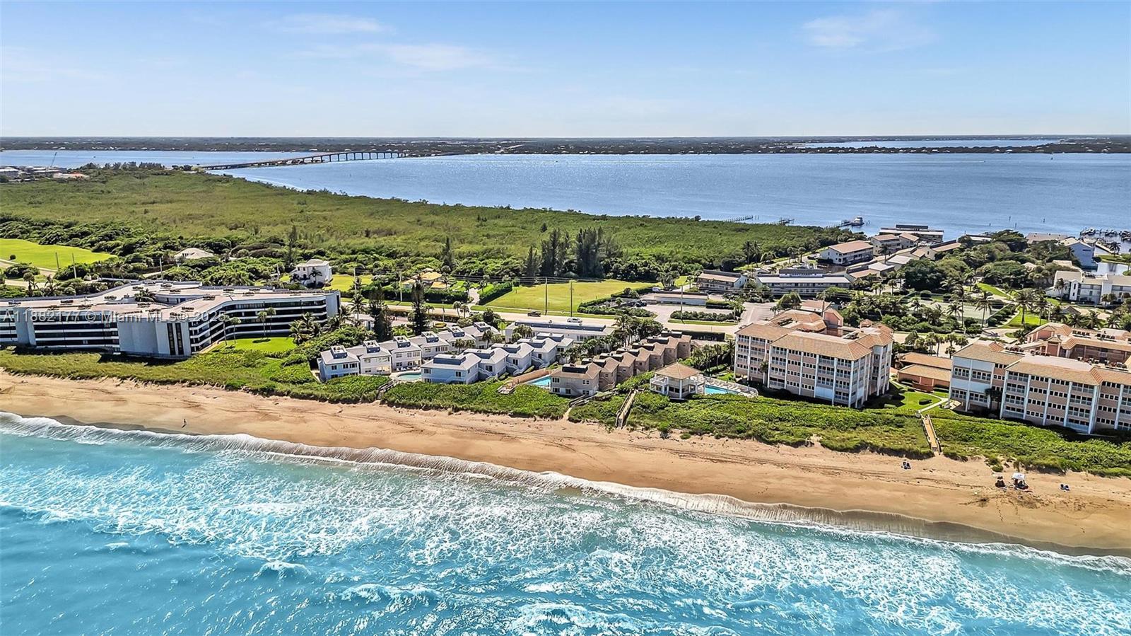 1456 Northeast Ocean Boulevard, Unit 7204 Stuart, FL 34996 - Photo 53 of 64 an aerial view of ocean and residential houses with outdoor space
