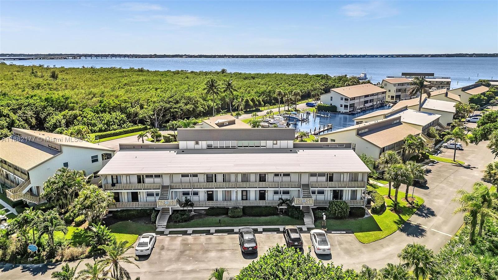 1456 Northeast Ocean Boulevard, Unit 7204 Stuart, FL 34996 - Photo 58 of 64 a large building with a swimming pool and outdoor space