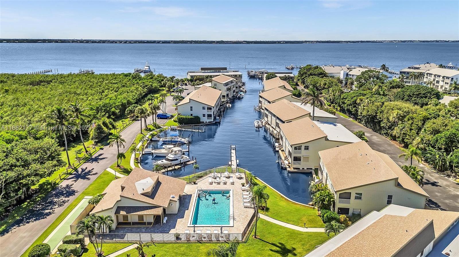1456 Northeast Ocean Boulevard, Unit 7204 Stuart, FL 34996 - Photo 60 of 64 an aerial view of a house with swimming pool and outdoor space
