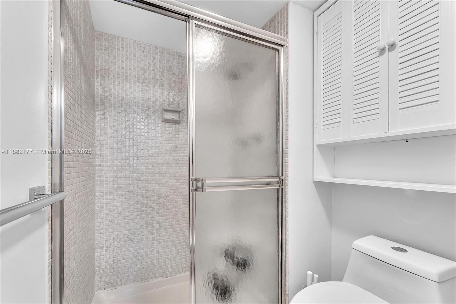 1456 Northeast Ocean Boulevard, Unit 7204 Stuart, FL 34996 - Photo 6 of 64 a bathroom with a shower and toilet