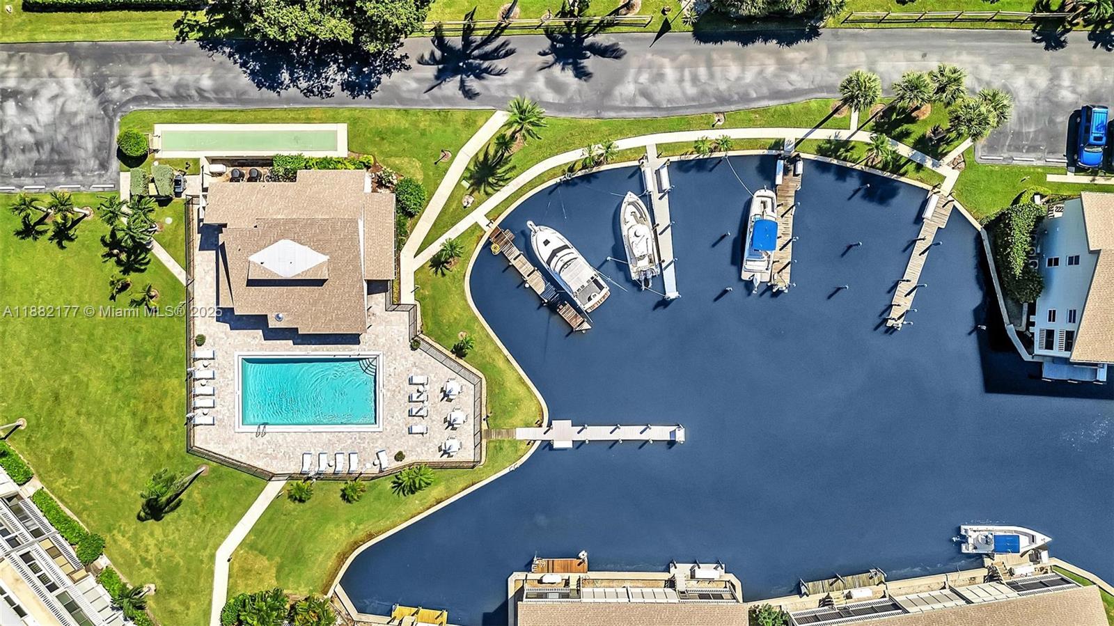 1456 Northeast Ocean Boulevard, Unit 7204 Stuart, FL 34996 - Photo 61 of 64 a view of swimming pool with a fireplace and a potted plant