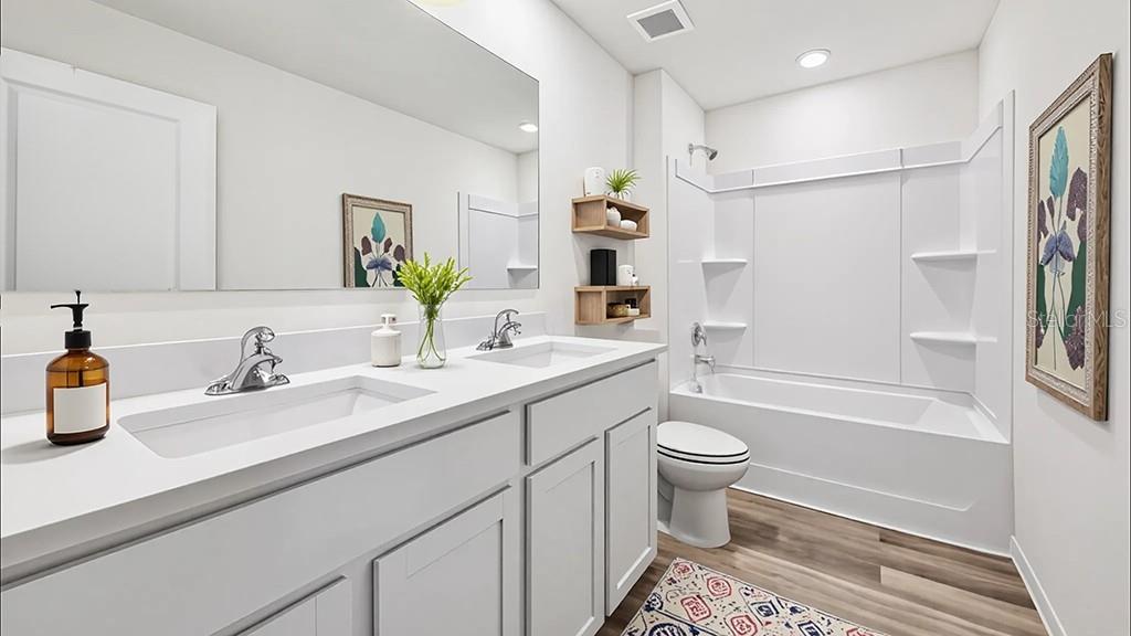 4671 Southwest 51st Terrace Gainesville, FL 32608 - Photo 12 of 15 a bathroom with a sink a toilet and shower