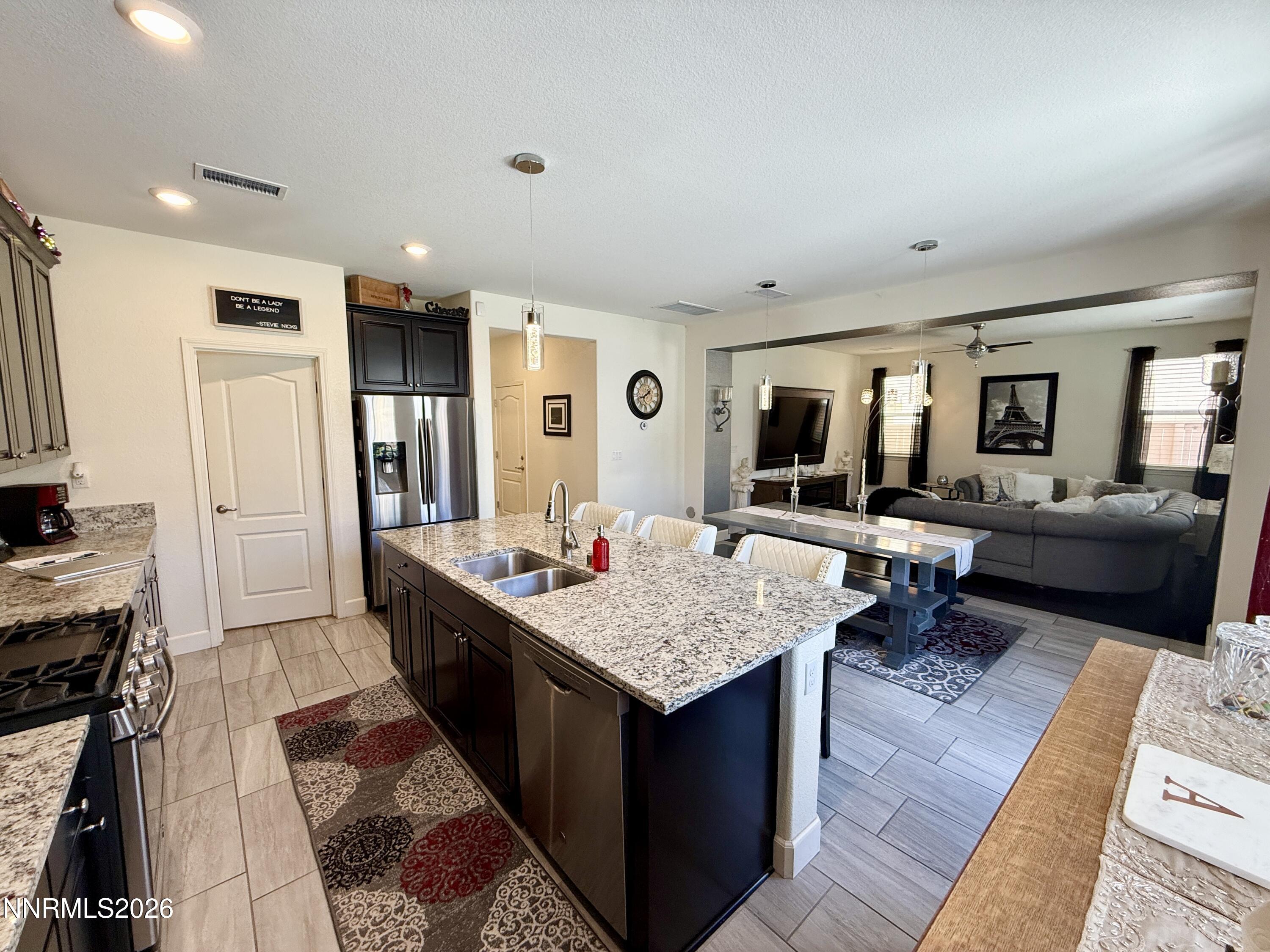 9766 Pachuca Drive Reno, NV 89521 - Photo 9 of 47 a living room with granite countertop furniture and a flat screen tv
