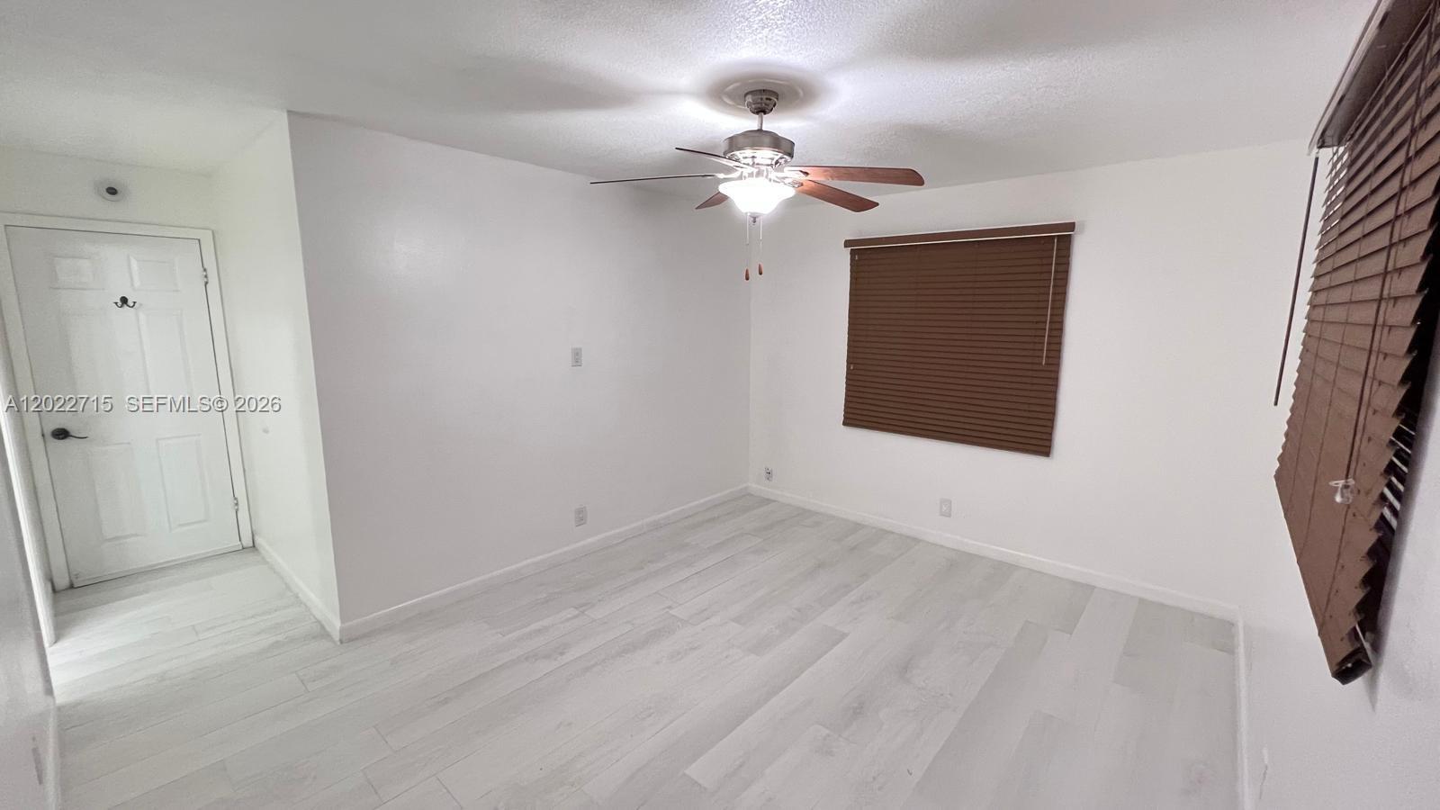 10669 Boca Entrada Boulevard Boca Raton, FL 33428 - Photo 11 of 19 a view of a livingroom with a fan