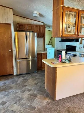 a kitchen with refrigerator and cabinets