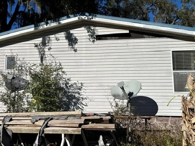 a view of a balcony with chairs and a potted plant