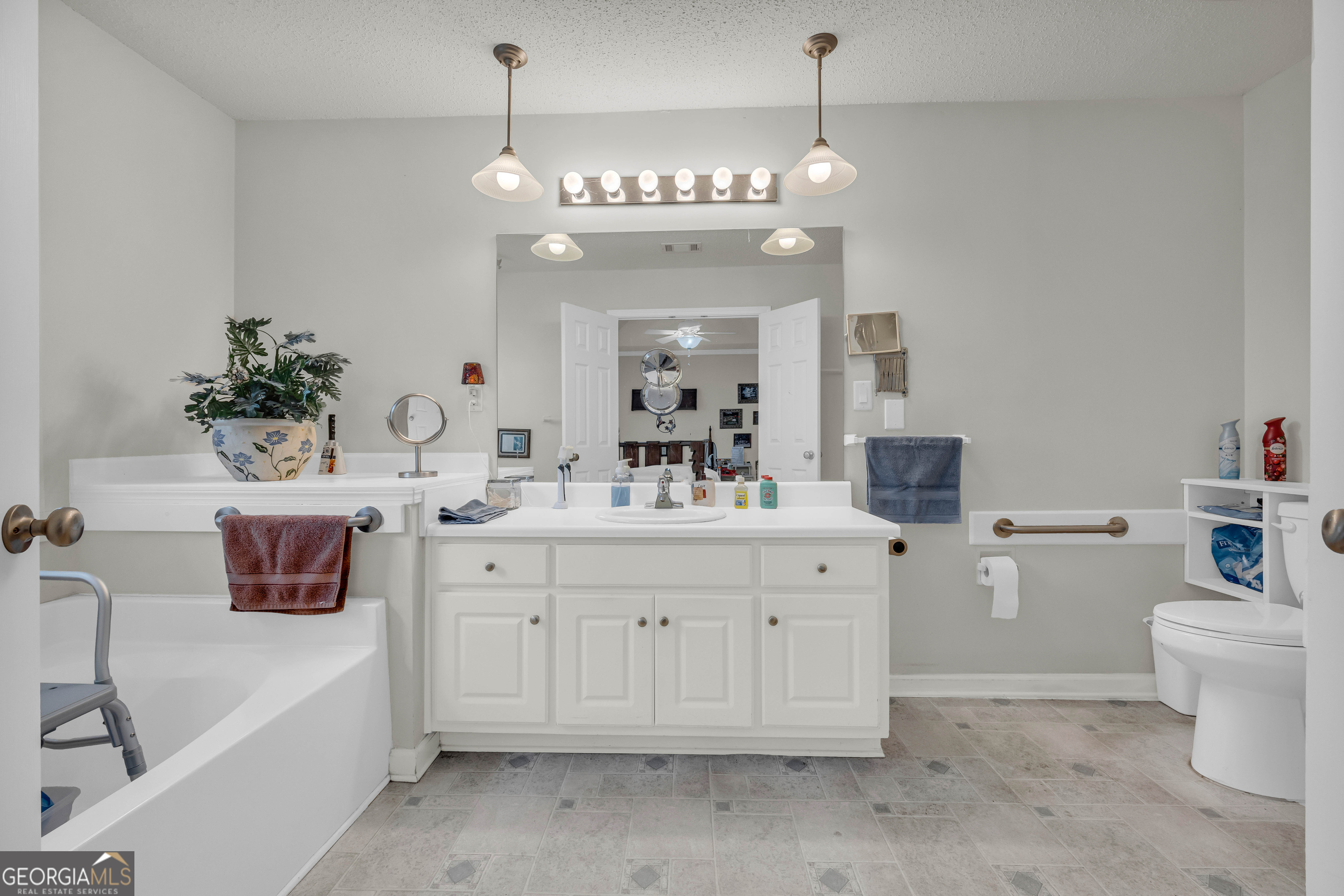 357 Sundew Lane Mount Airy, GA 30563 - Photo 28 of 53 a spacious bathroom with a sink a large mirror and a toilet