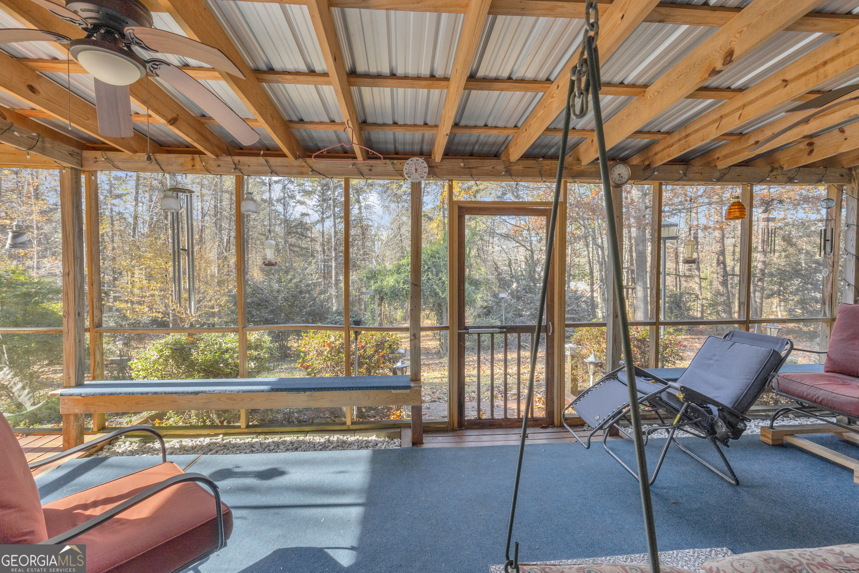 357 Sundew Lane Mount Airy, GA 30563 - Photo 37 of 53 a living room with furniture and a floor to ceiling window