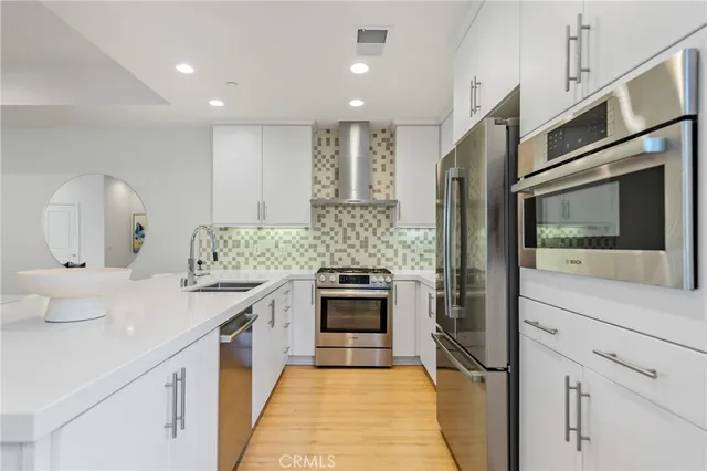 a kitchen with a sink stove and refrigerator