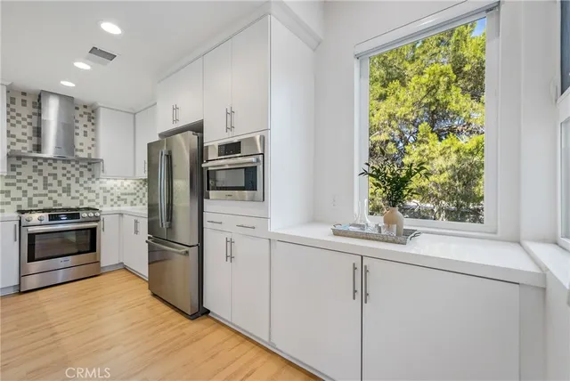 a kitchen with appliances cabinets and a sink