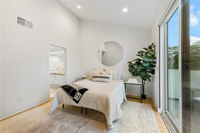 a bedroom with bed and a potted plant