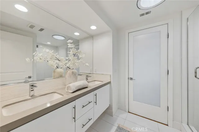 a bathroom with a double vanity sink and a mirror