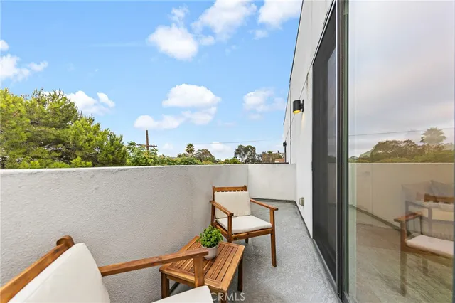 a view of a chairs and table in a balcony