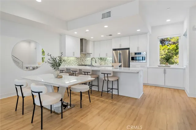 a kitchen with a table and chairs in it