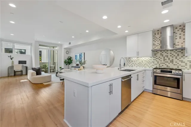 a kitchen with sink stove and cabinets