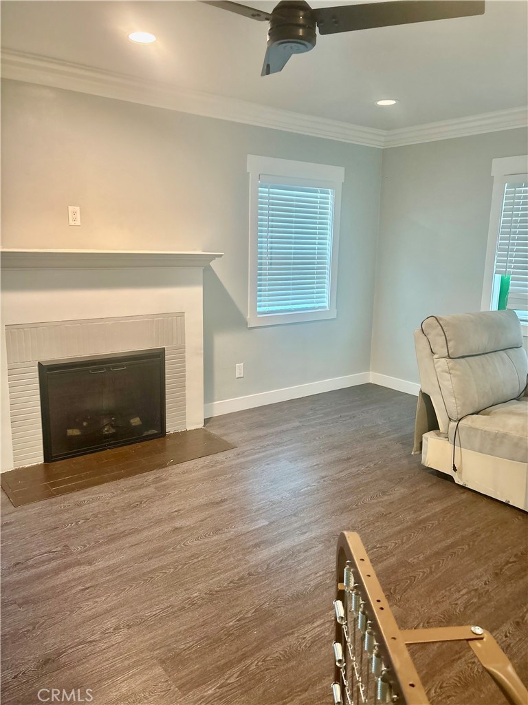 1503 North Chester Avenue Compton, CA 90221 - Photo 14 of 18 a view of an empty room with wooden floor and a fireplace
