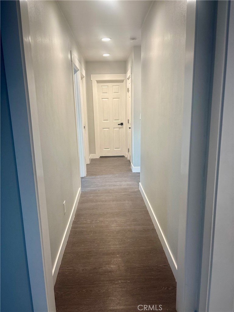 1503 North Chester Avenue Compton, CA 90221 - Photo 5 of 18 a view of a hallway with wooden floor and a glass door