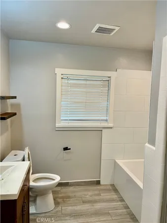 a bathroom with a toilet a sink and bathtub