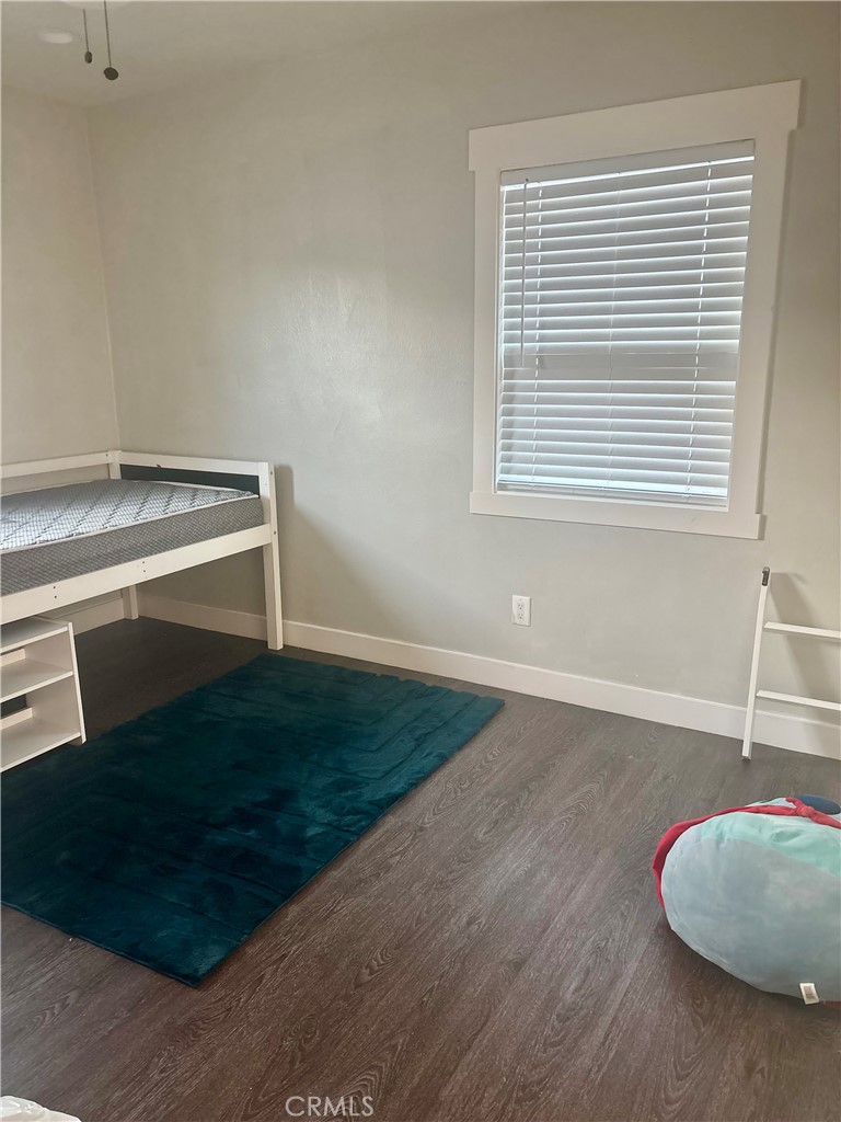 1503 North Chester Avenue Compton, CA 90221 - Photo 9 of 18 an empty room with wooden floor and windows