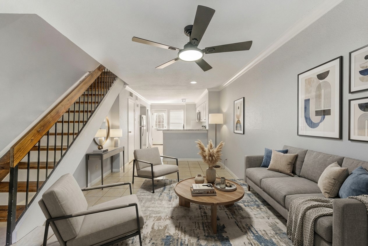 a living room with furniture kitchen view and a chandelier