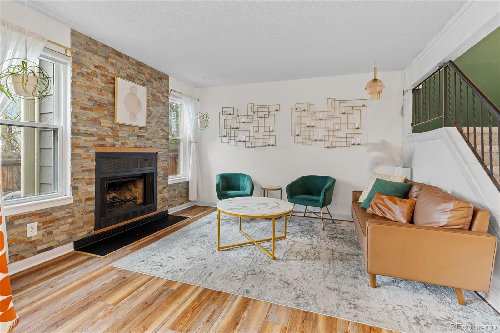 8674 Carr Loop Arvada, CO 80005 - Photo 11 of 43 a living room with furniture and a fireplace