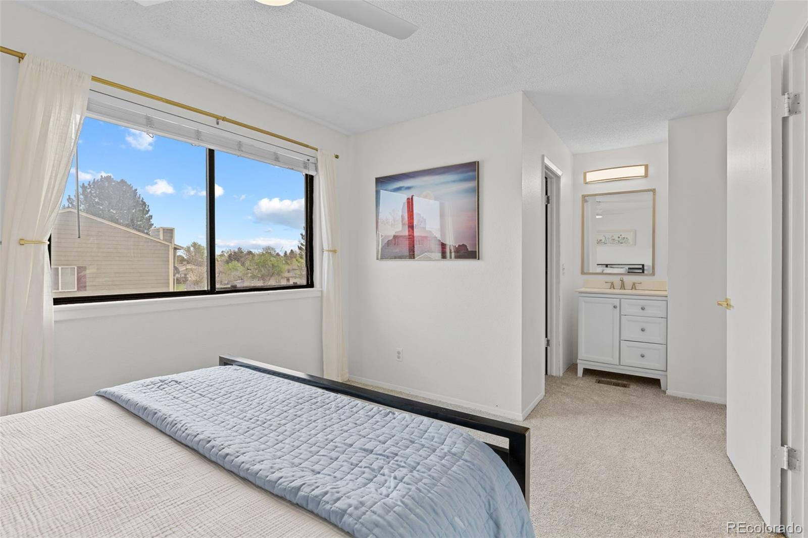 8674 Carr Loop Arvada, CO 80005 - Photo 18 of 43 a view of a bedroom with bed and window