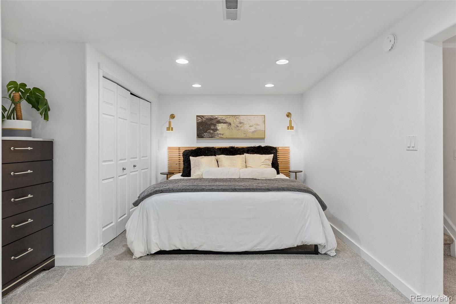 8674 Carr Loop Arvada, CO 80005 - Photo 26 of 43 a bedroom with a bed and painting on the wall