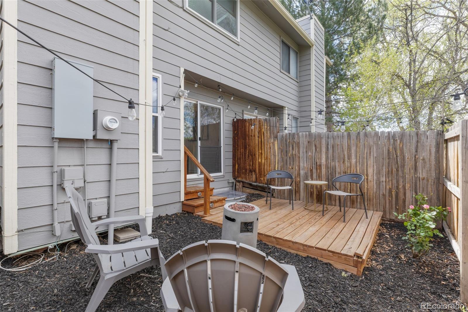 8674 Carr Loop Arvada, CO 80005 - Photo 32 of 43 a view of an outdoor sitting area with brick walls