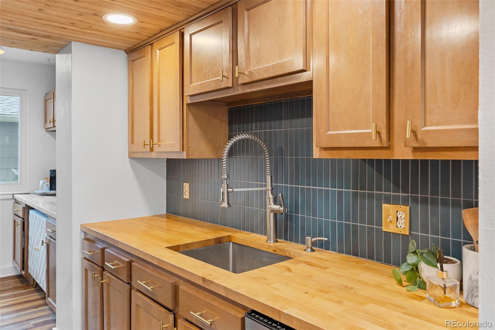 8674 Carr Loop Arvada, CO 80005 - Photo 5 of 43 a kitchen with a sink and cabinets
