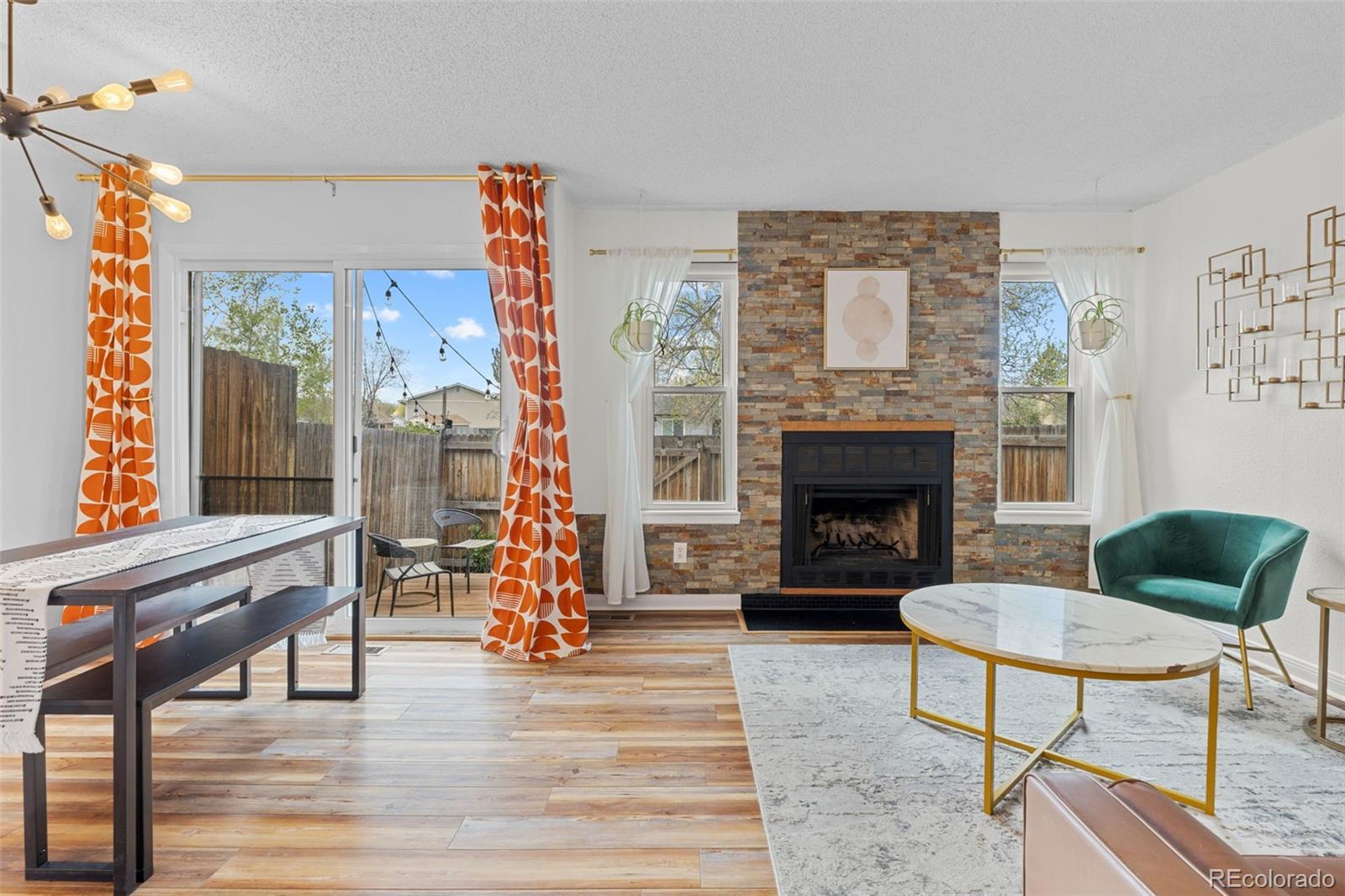 8674 Carr Loop Arvada, CO 80005 - Photo 10 of 43 a living room with furniture and a fireplace