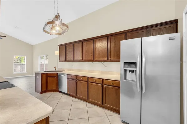 a kitchen with stainless steel appliances granite countertop a refrigerator and a sink