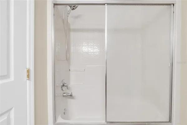 a bathroom with a glass shower door