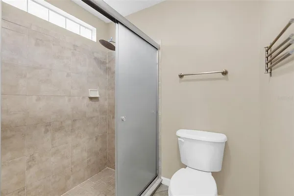 a bathroom with a toilet and a shower